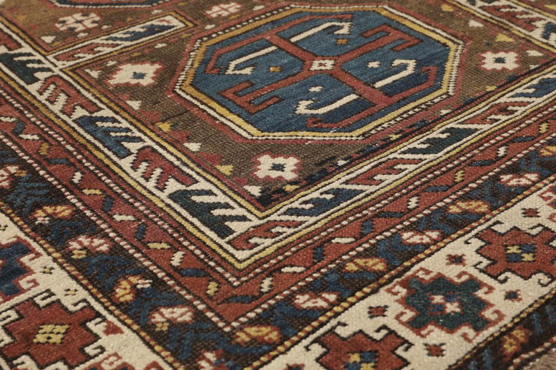 Antiek Shirvan-tapijt uit Azerbeidzjan in bruin met traditionele geometrische motieven.