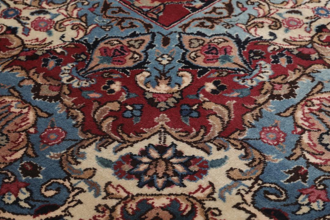 Hand-knotted Mashad rug from the Middle East in dark-red with floral pattern