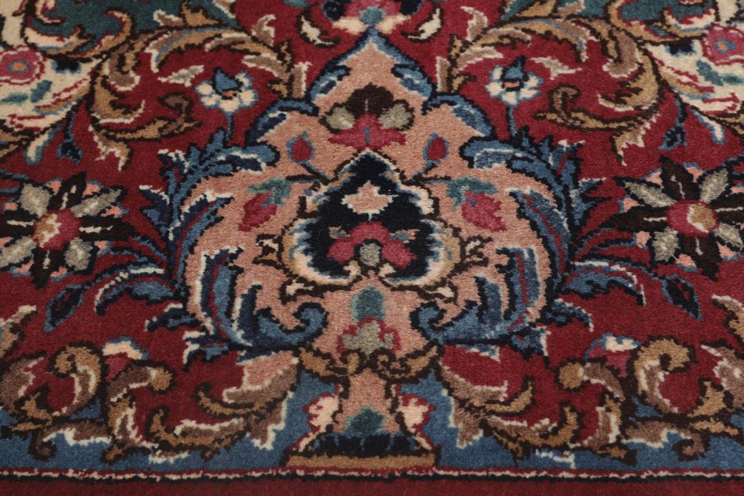 Hand-knotted Mashad rug from the Middle East in dark-red with floral pattern