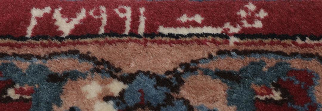 Hand-knotted Mashad rug from the Middle East in dark-red with floral pattern