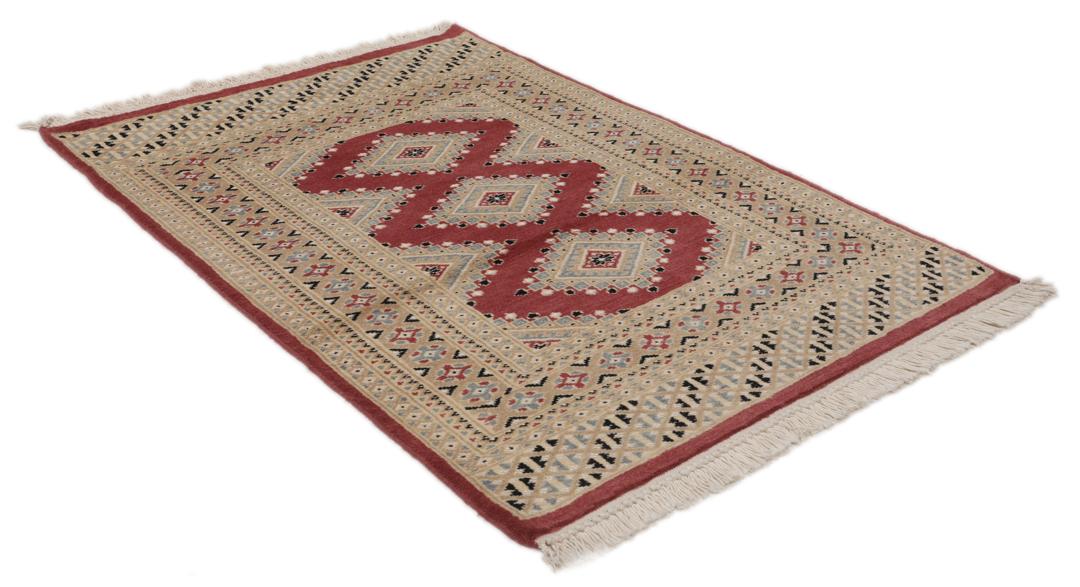 A hand-knotted red Pakistan Bokhara 2ply rug with geometric diamond motifs.