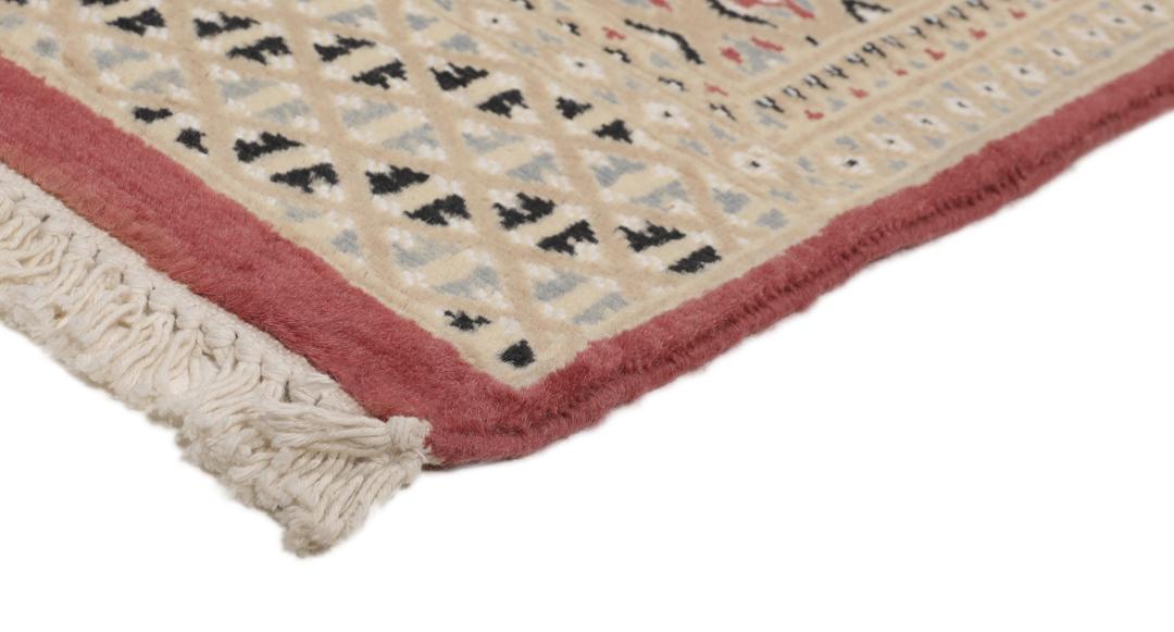 A hand-knotted red Pakistan Bokhara 2ply rug with geometric diamond motifs.