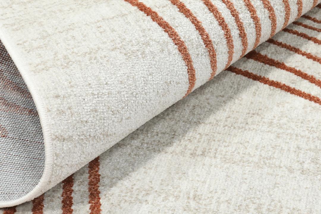 roestbruin vloerkleed met geometrisch patroon en franjes