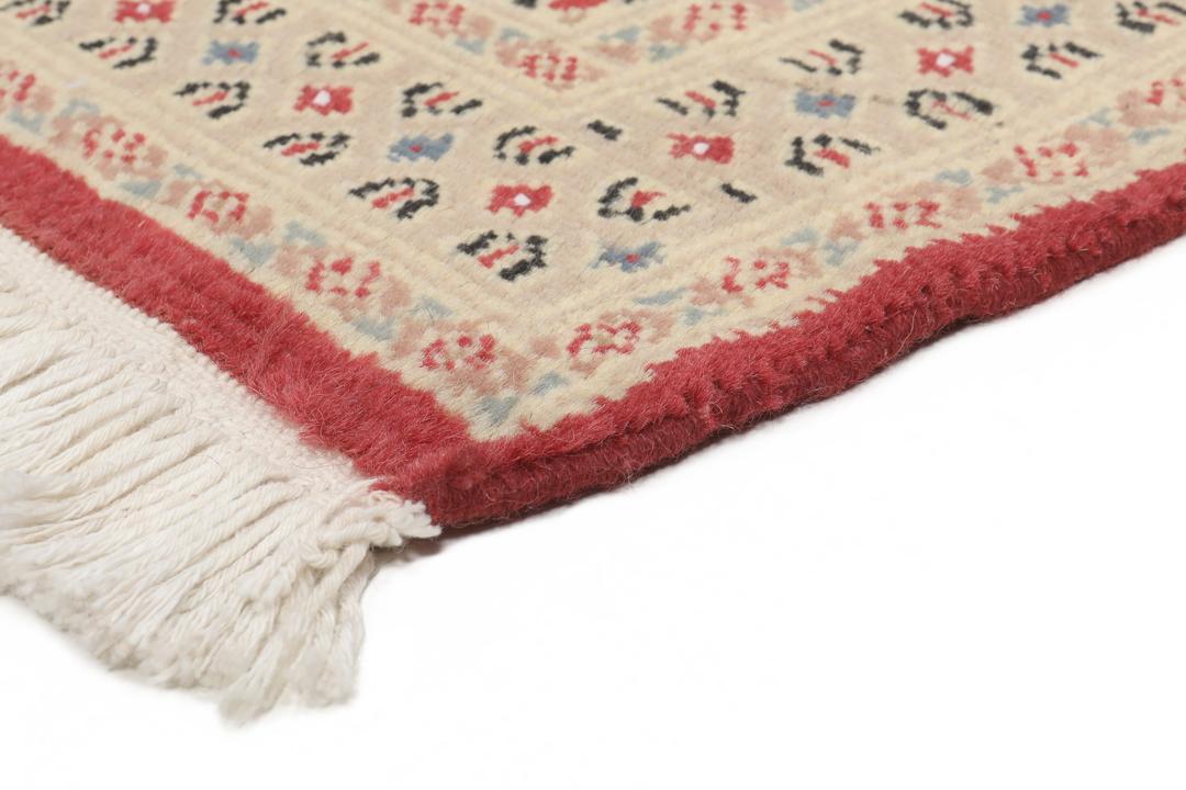 A hand-knotted Pakistan Bokhara 2ply rug featuring geometric patterns in red and beige tones.