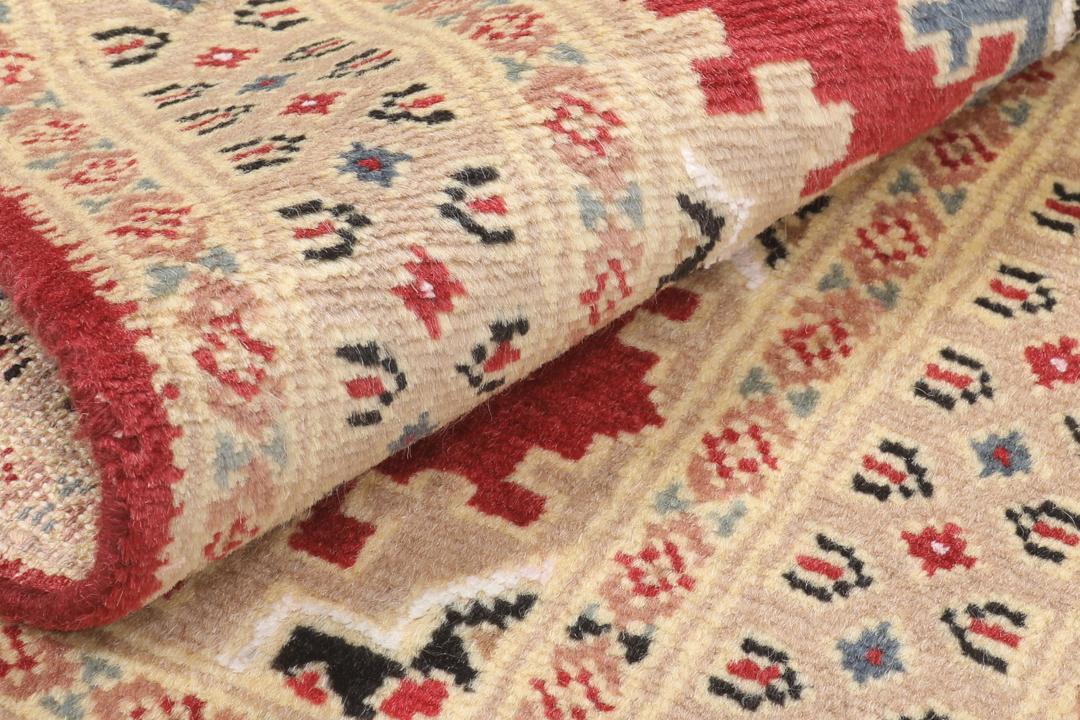 A hand-knotted Pakistan Bokhara 2ply rug featuring geometric patterns in red and beige tones.