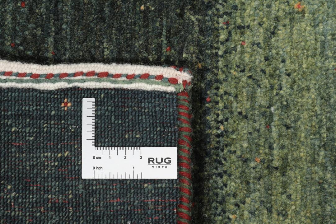 Håndknyttet Loribaft-tæppe fra Mellemøsten i mørkegrønne og røde nuancer