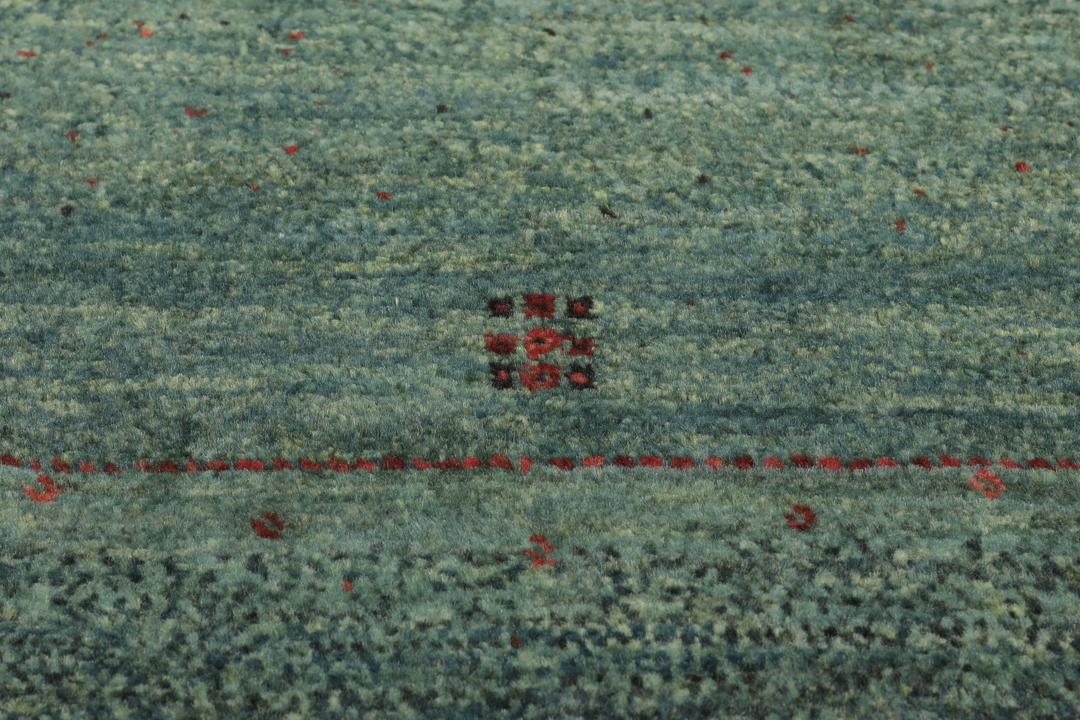 Et håndknyttet mellemøstligt Loribaft Fine-tæppe i mørkegrøn.