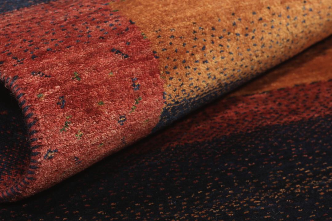Hand-knotted Loribaft wool rug from the Middle East in red, orange, and blue.