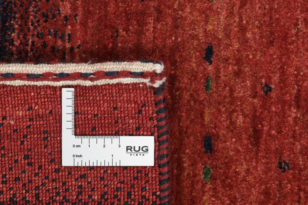 Hand-knotted Loribaft wool rug from the Middle East in red, orange, and blue.