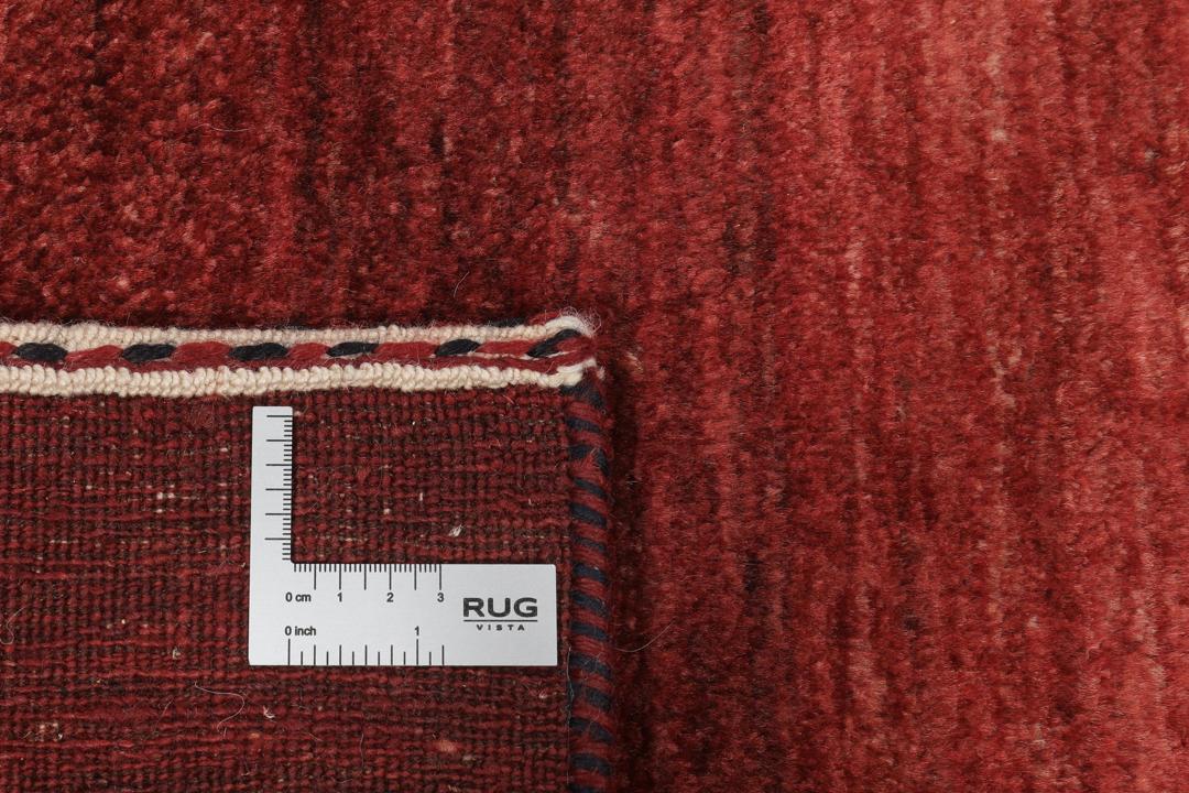 Håndknyttet tæppe fra Mellemøsten i dyb rød