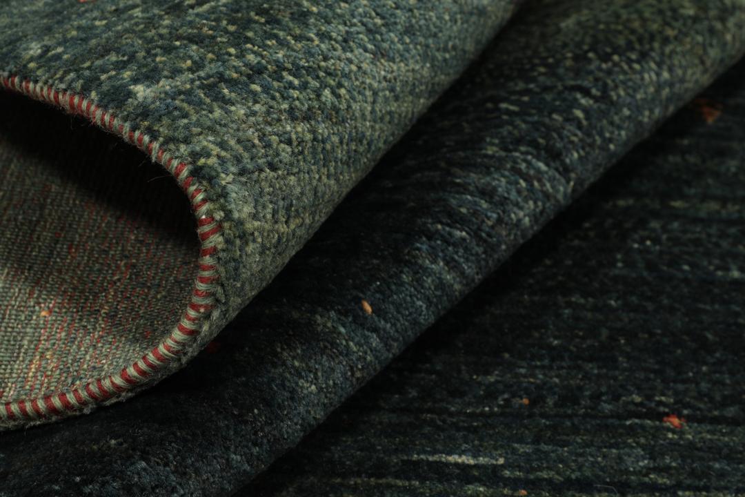 Hand-knotted Loribaft Fine rug from the Middle East in dark-green.