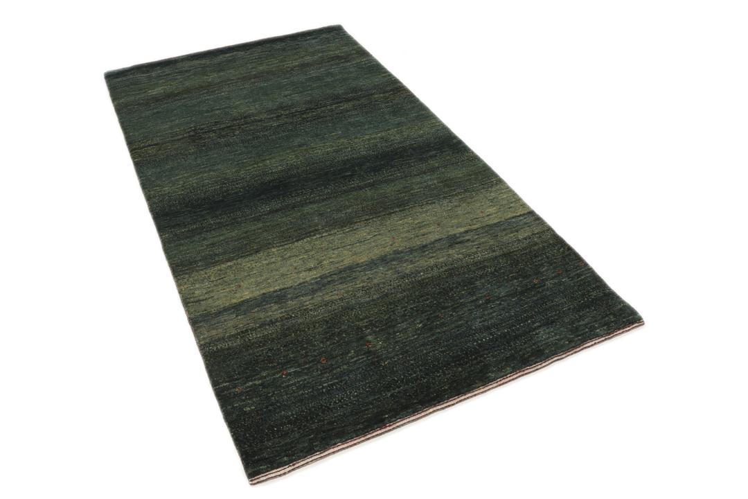 Hand-knotted Loribaft rug from the Middle East in deep forest green and earthy tones