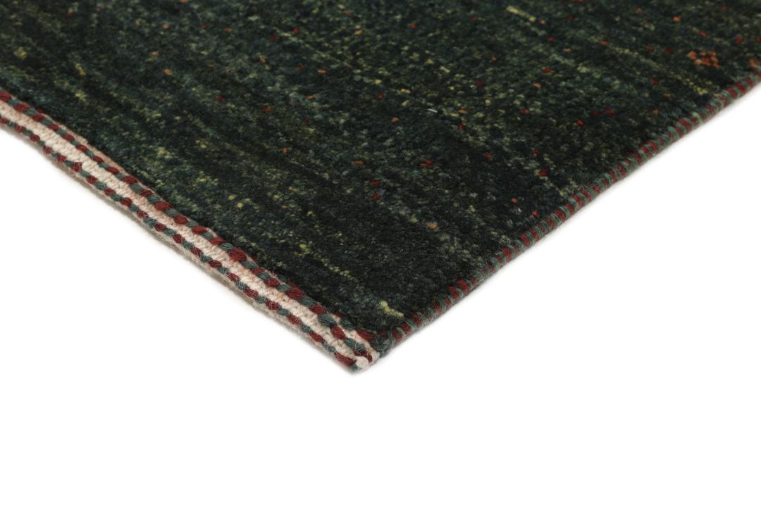 Hand-knotted Loribaft rug from the Middle East in deep forest green and earthy tones