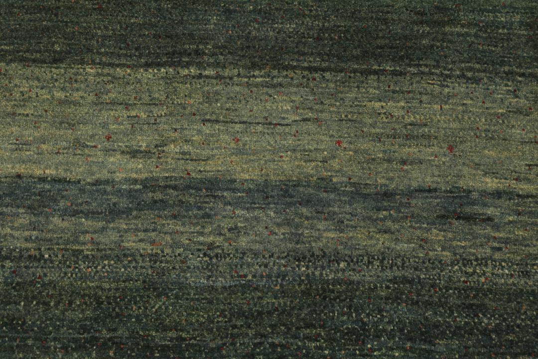 Hand-knotted Loribaft rug from the Middle East in deep forest green and earthy tones