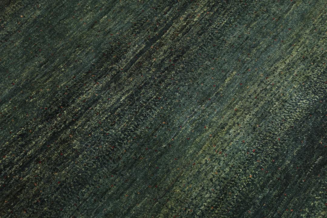Hand-knotted Loribaft rug from the Middle East in deep forest green and earthy tones