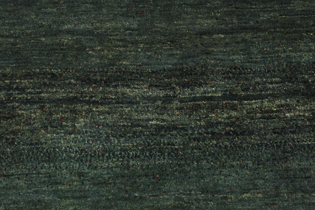 Hand-knotted Loribaft rug from the Middle East in deep forest green and earthy tones