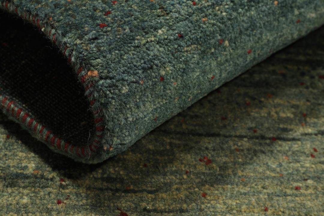Hand-knotted Loribaft rug from the Middle East in deep forest green and earthy tones