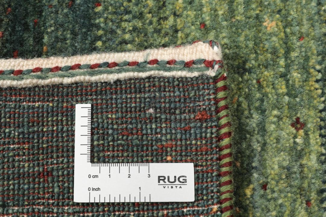 Håndknyttet grønt uldtæppe af typen Loribaft fra Mellemøsten