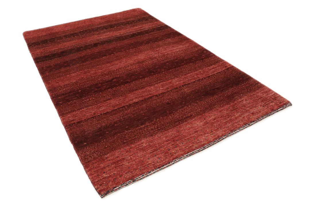 A hand-knotted Loribaft Fine rug from the Middle East in deep red tones.