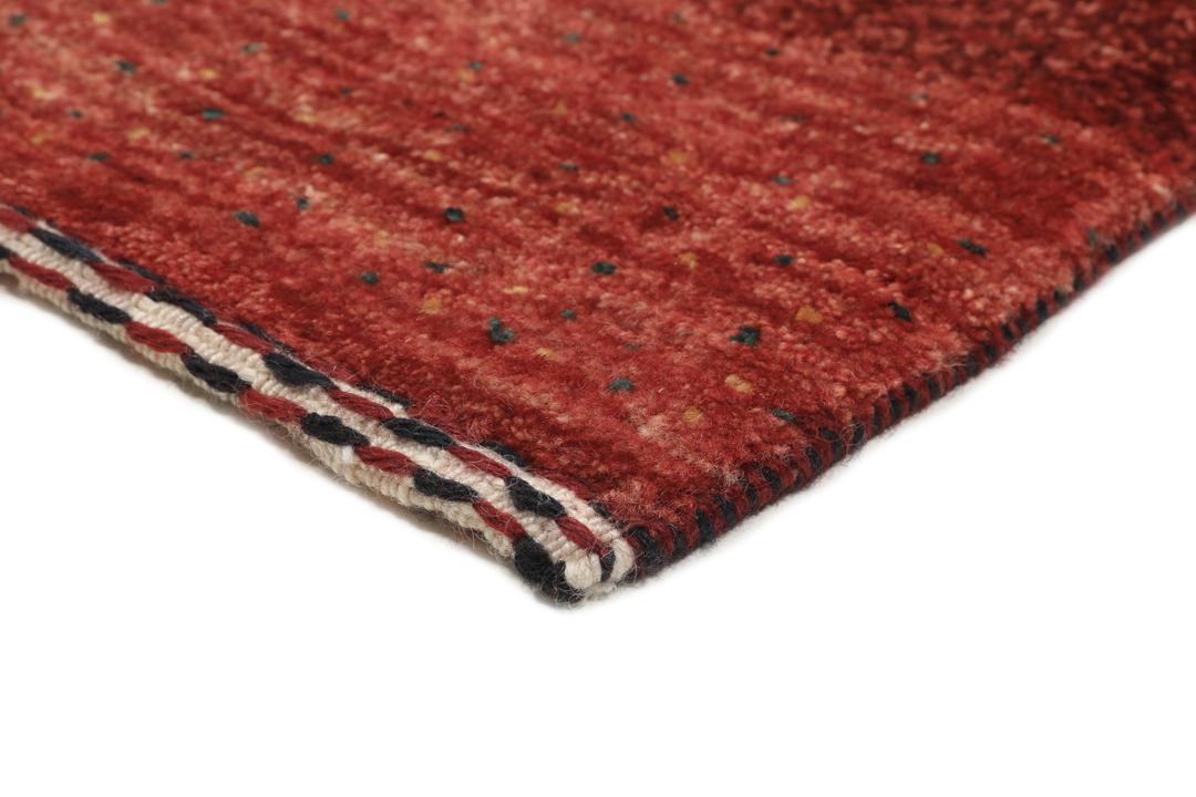 A hand-knotted Loribaft Fine rug from the Middle East in deep red tones.