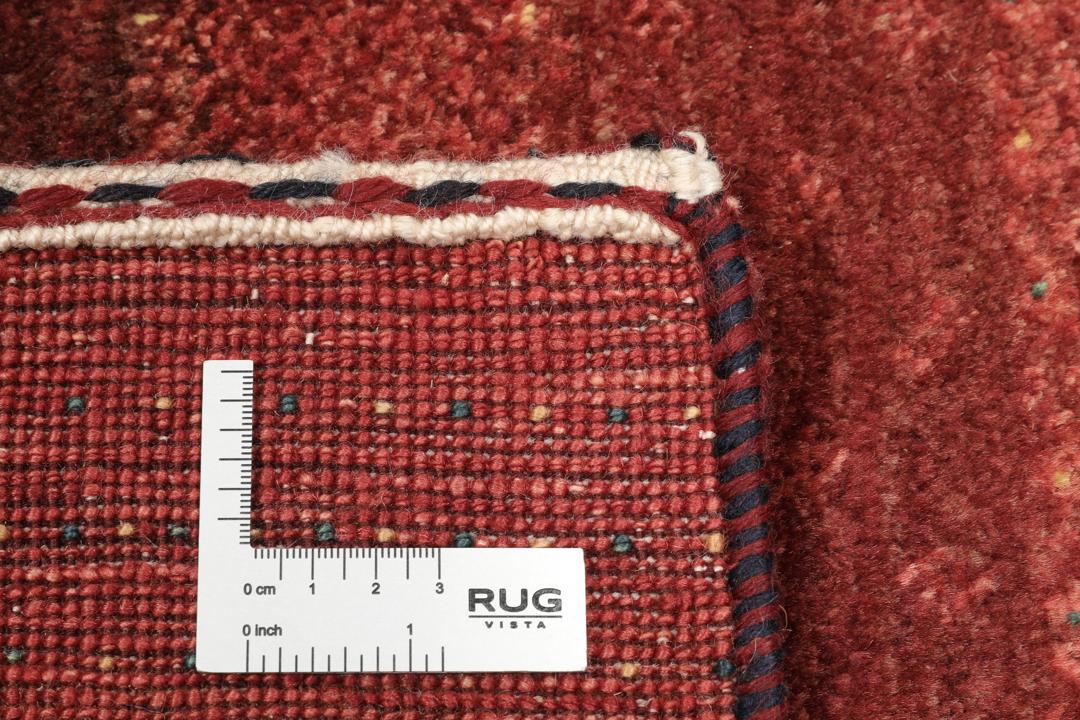 A hand-knotted Loribaft Fine rug from the Middle East in deep red tones.