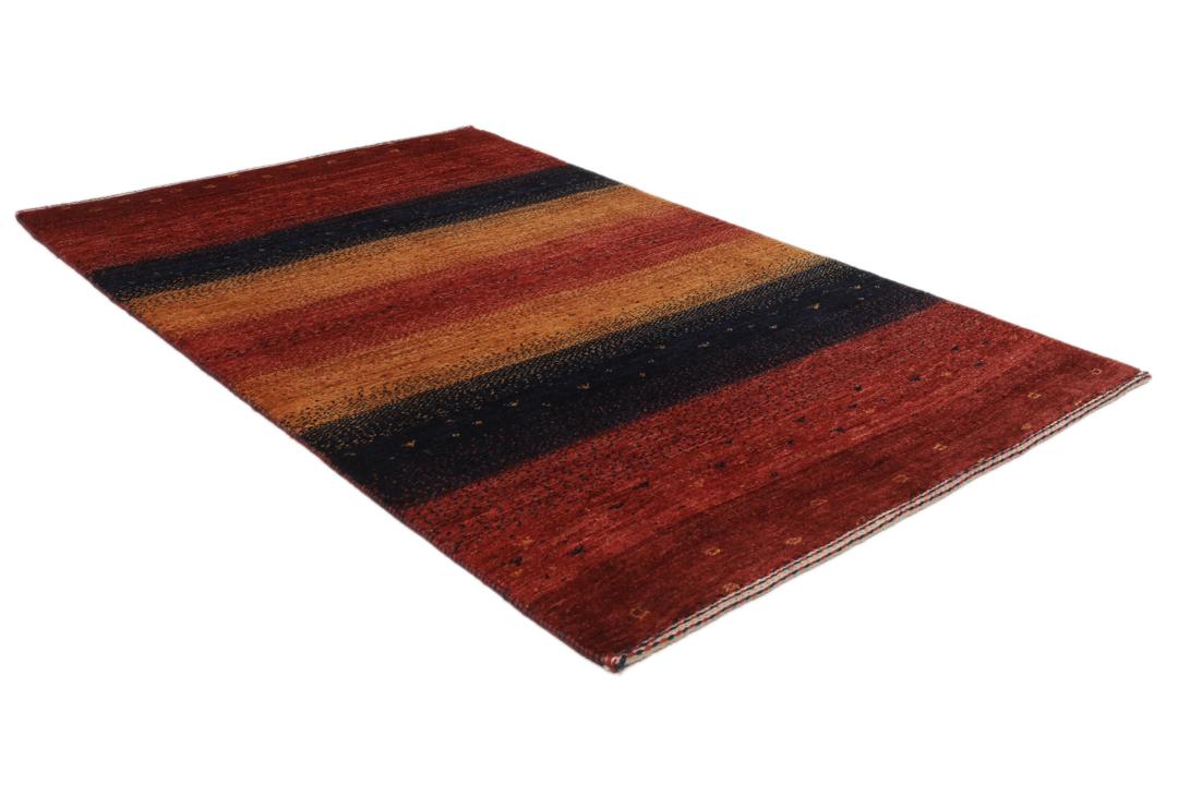 A hand-knotted Loribaft rug with earthy red, orange, and blue stripes from the Middle East