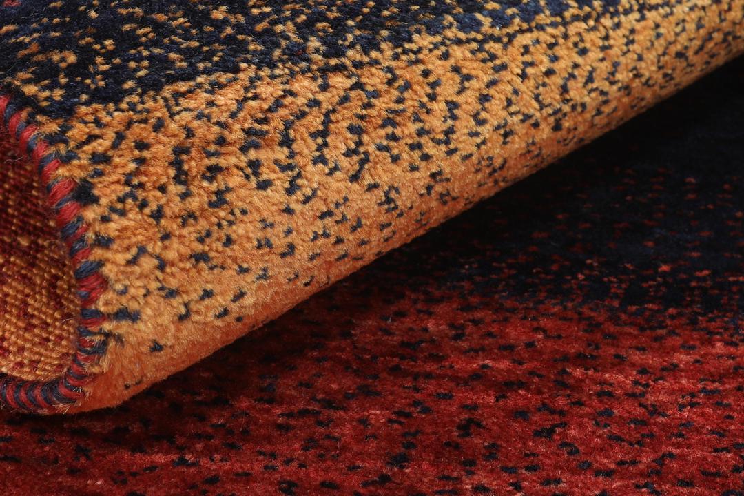 A hand-knotted Loribaft rug with earthy red, orange, and blue stripes from the Middle East