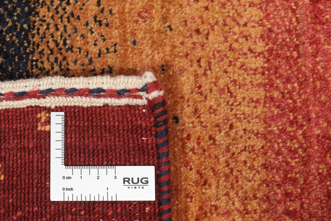 A hand-knotted Loribaft rug with earthy red, orange, and blue stripes from the Middle East