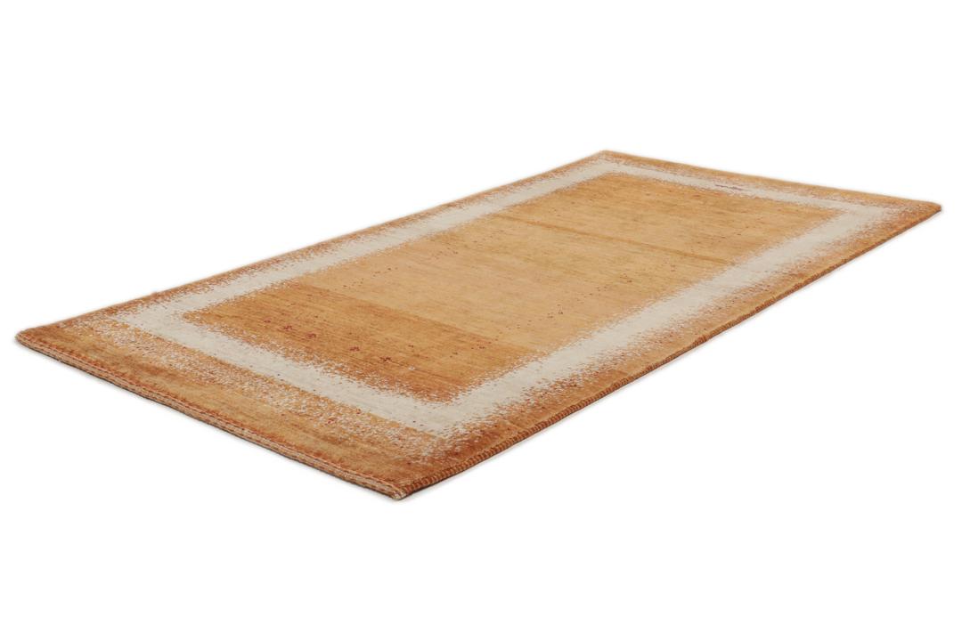 Hand-knotted Loribaft rug with a rich red and beige colour palette.