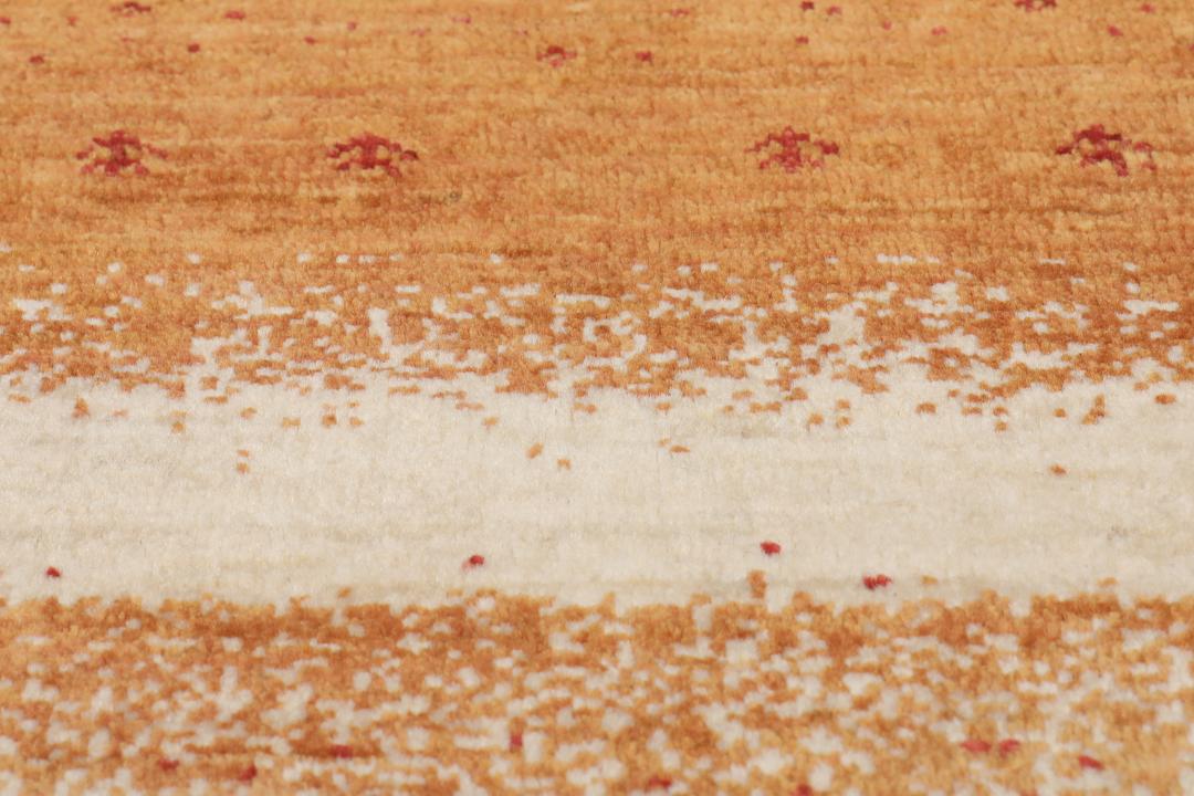Hand-knotted Loribaft rug with a rich red and beige colour palette.
