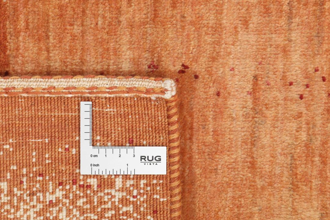Hand-knotted Loribaft rug with a rich red and beige colour palette.