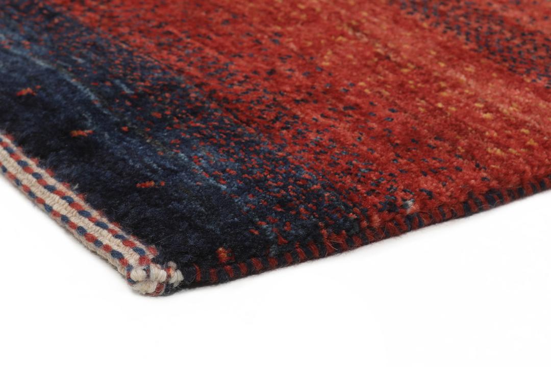 Hand-knotted Loribaft rug from the Middle East in deep red and dark-blue tones.