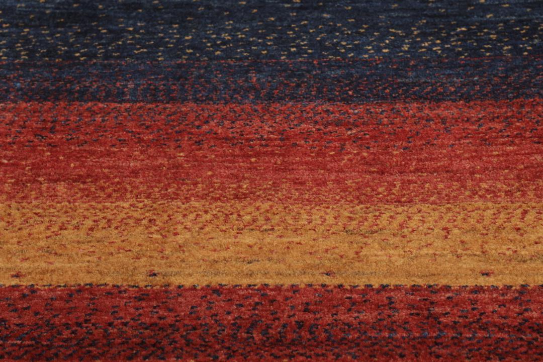 Hand-knotted Loribaft rug from the Middle East in deep red and dark-blue tones.