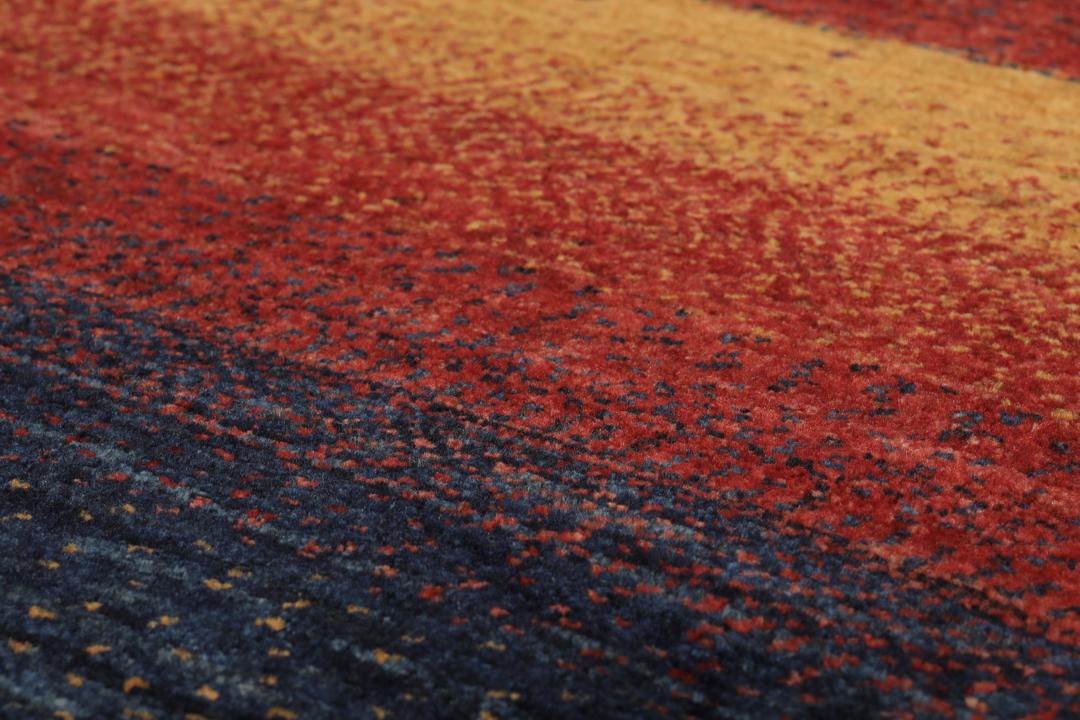 Hand-knotted Loribaft rug from the Middle East in deep red and dark-blue tones.
