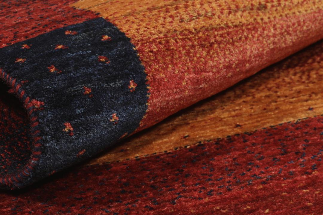 Hand-knotted Loribaft rug from the Middle East in deep red and dark-blue tones.
