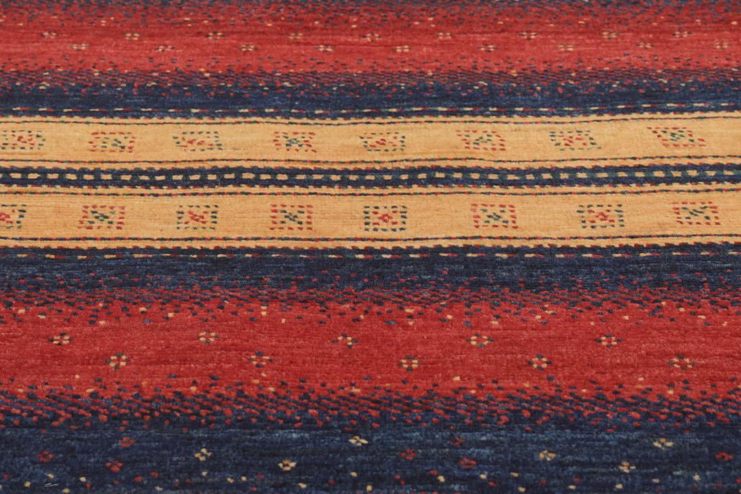 A hand-knotted Middle Eastern Loribaft rug featuring a striped pattern in red, blue, and beige wool.