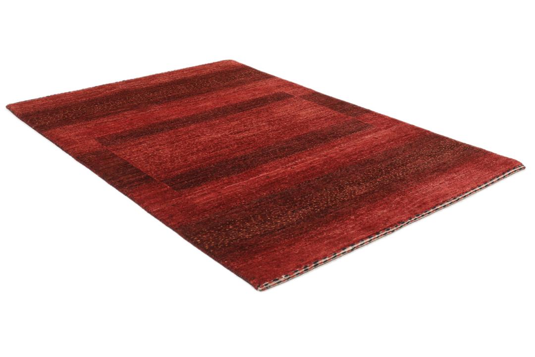 Hand-knotted red wool rug from the Middle East