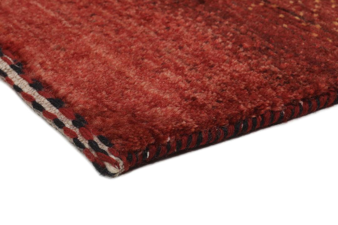 Hand-knotted red wool rug from the Middle East