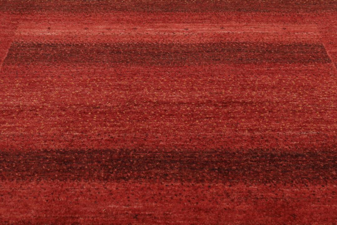 Hand-knotted red wool rug from the Middle East