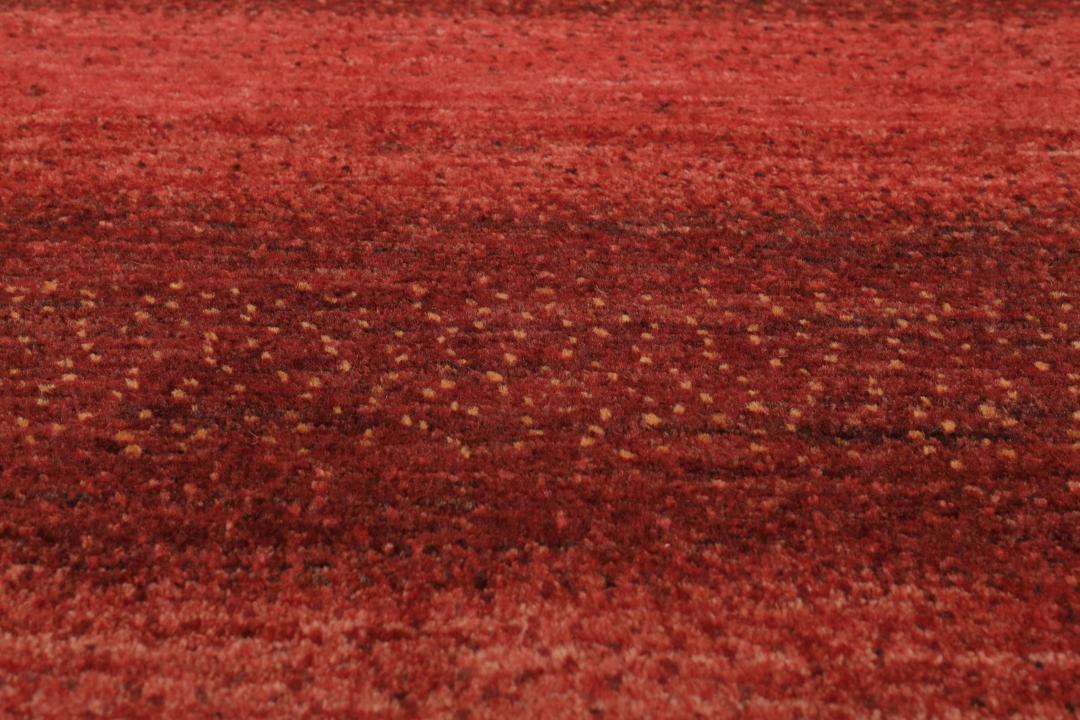 Hand-knotted red wool rug from the Middle East