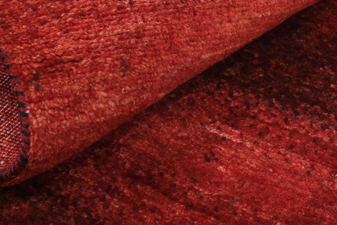 Hand-knotted red wool rug from the Middle East