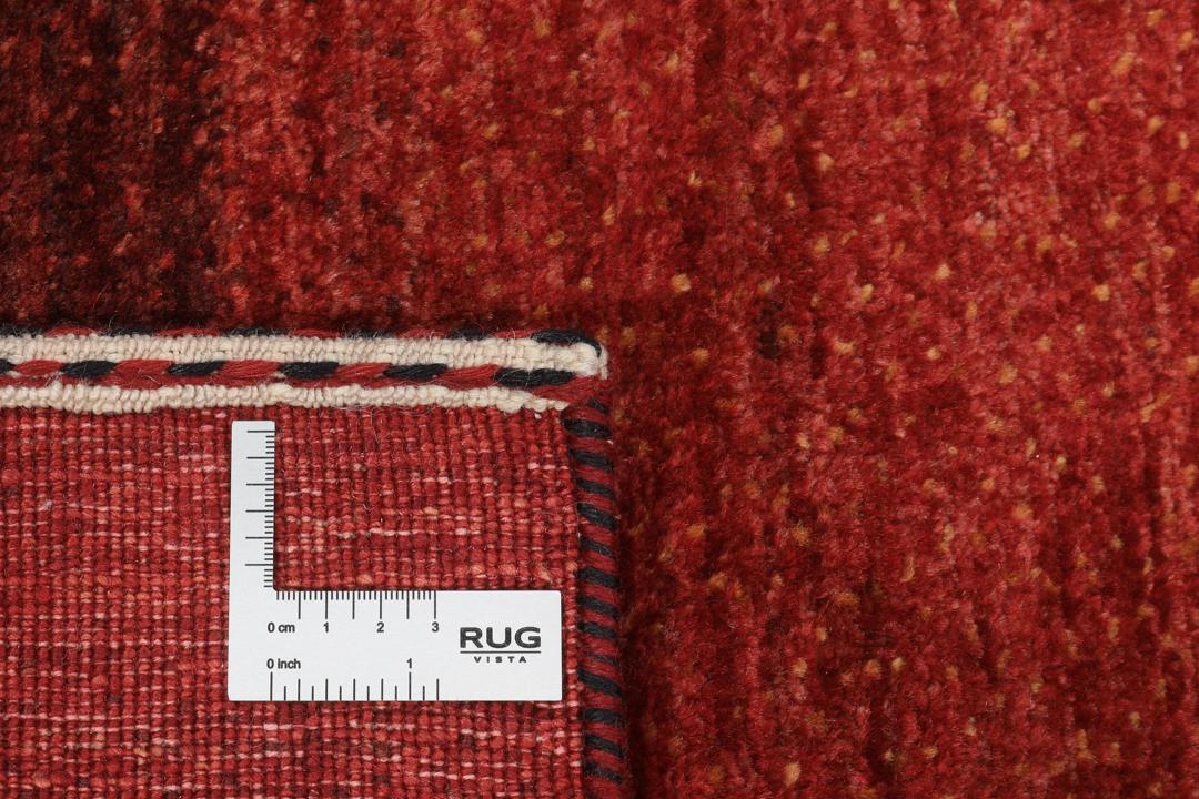 Hand-knotted red wool rug from the Middle East