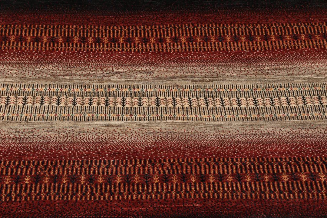 A hand-knotted Loribaft Fine rug from the Middle East featuring red, black, and beige stripes.