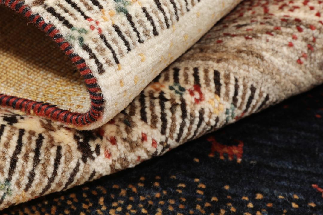 A hand-knotted Loribaft Fine rug from the Middle East featuring red, black, and beige stripes.