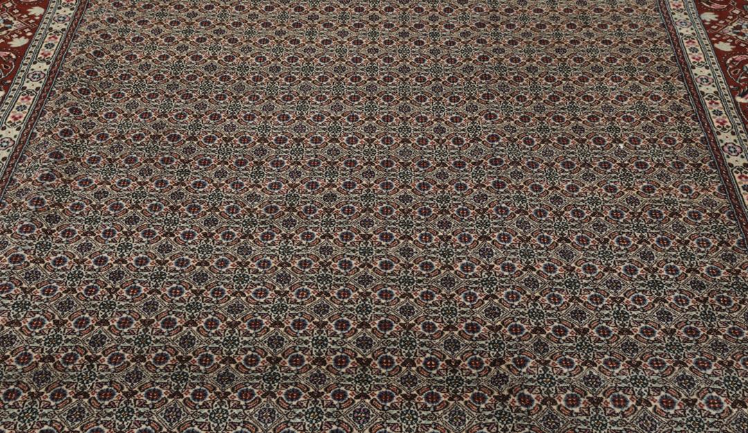 A hand-knotted Moud Wool rug from the Middle East in dark-red and beige tones.
