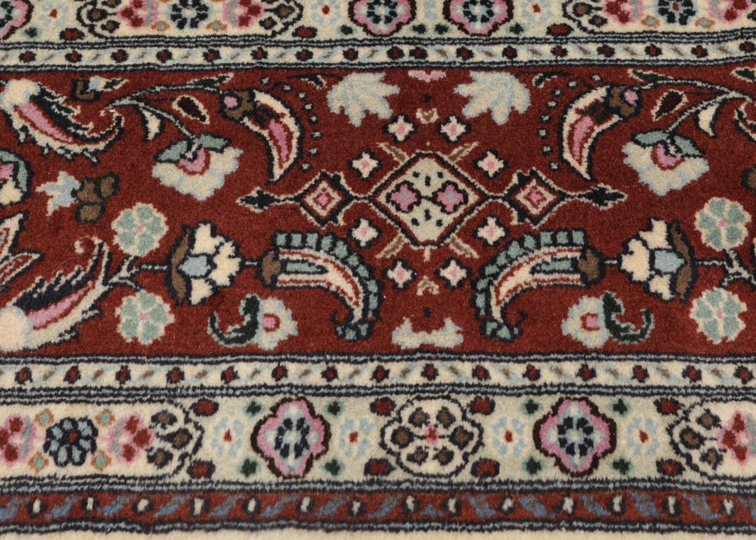 A hand-knotted Moud Wool rug from the Middle East in dark-red and beige tones.