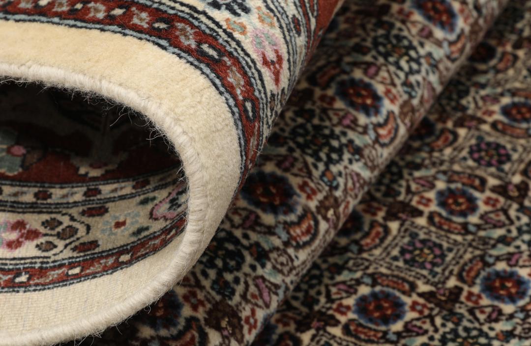 A hand-knotted Moud Wool rug from the Middle East in dark-red and beige tones.