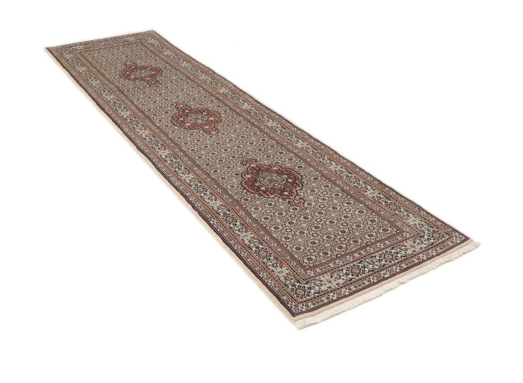 A hand-knotted Moud runner rug with a floral design in multicolor tones