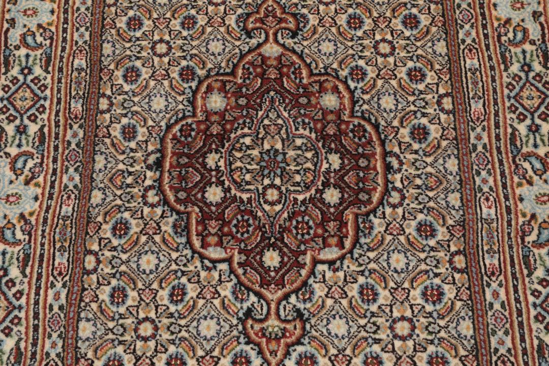 A hand-knotted Moud runner rug with a floral design in multicolor tones