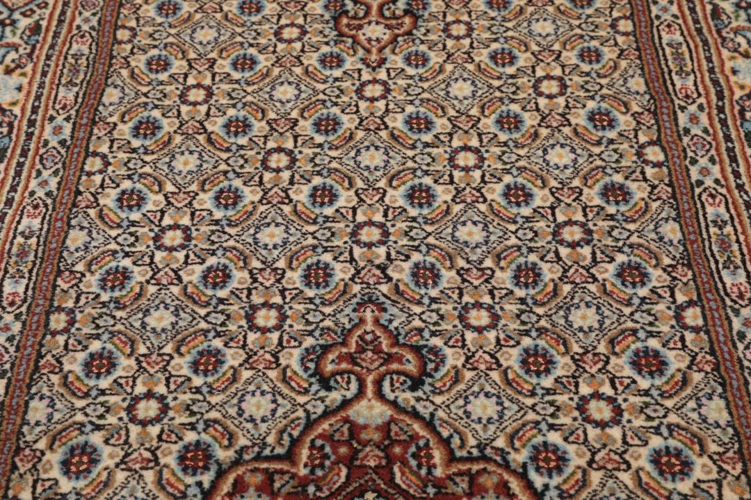 A hand-knotted Moud runner rug with a floral design in multicolor tones